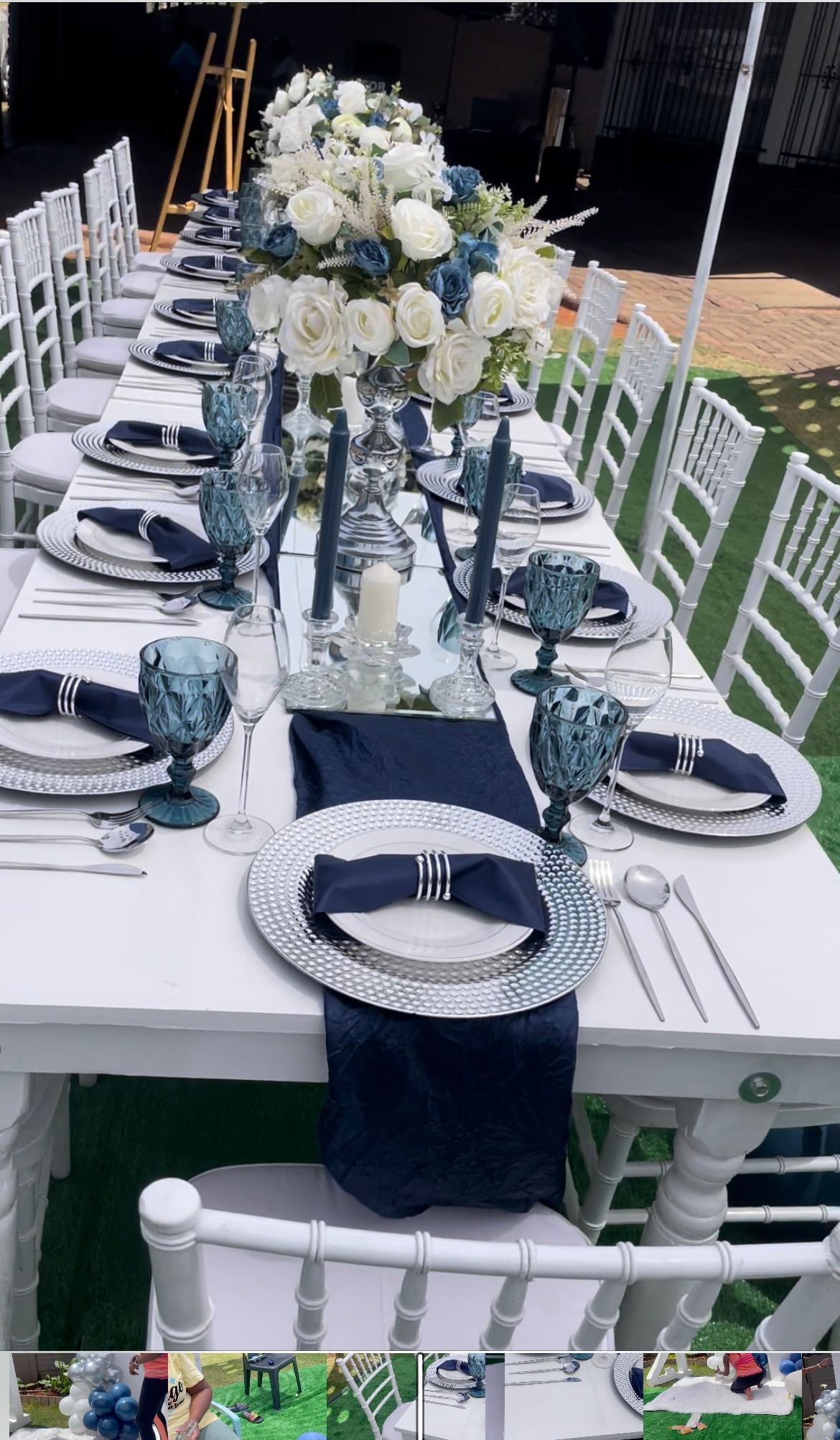 Styled event setup with draped marquee canopy and formal table layout