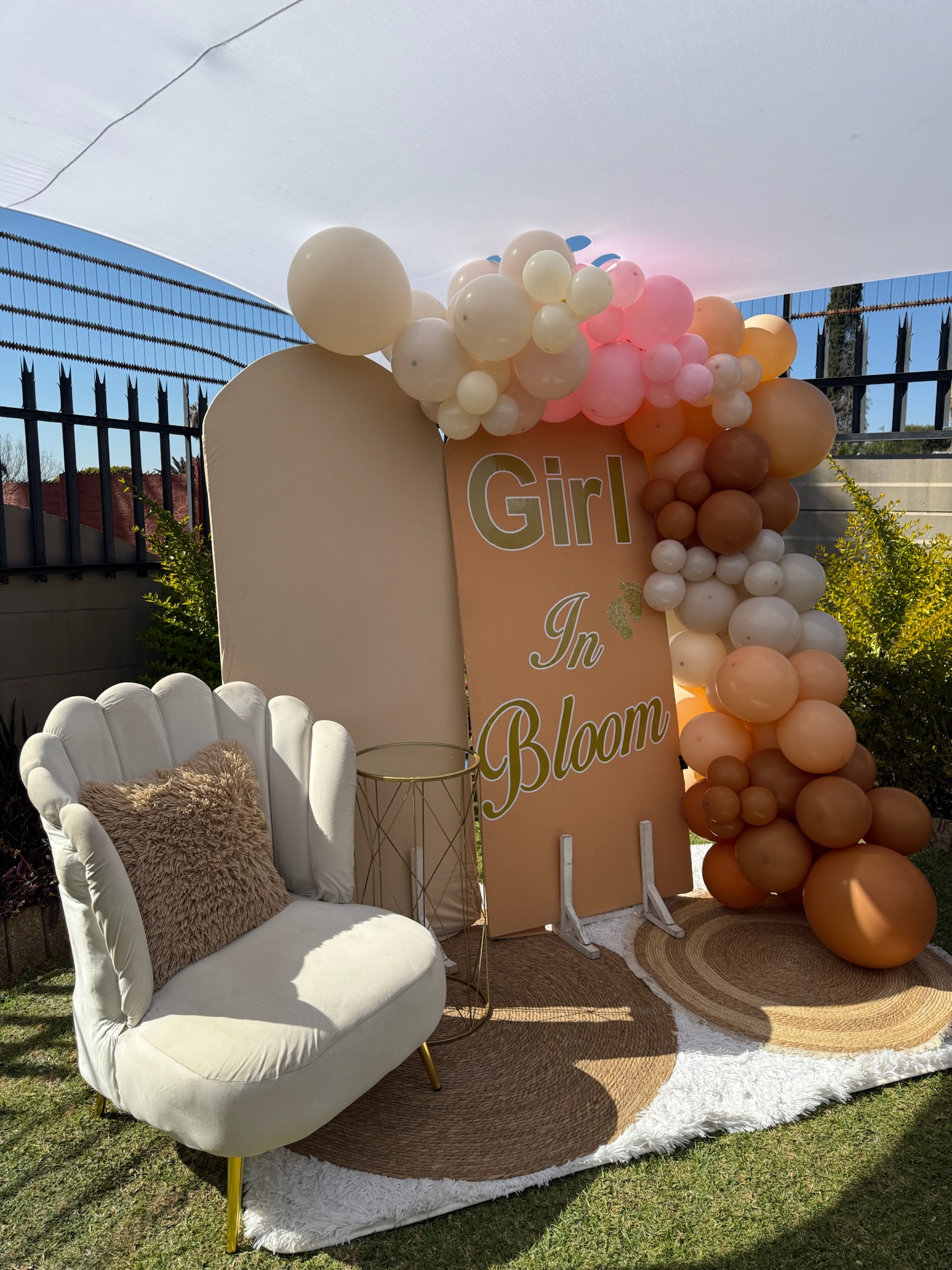 Close-up of picnic table setting with champagne flutes and white flower centrepiece