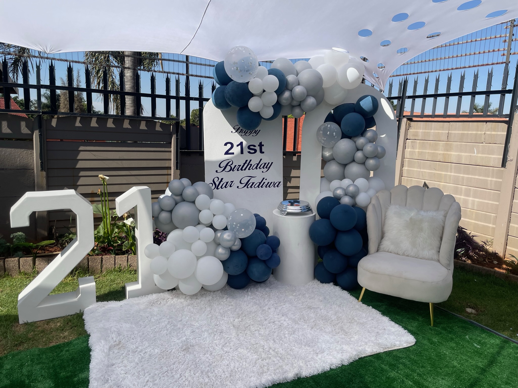 Outdoor evening event with fairy lights and styled table arrangements