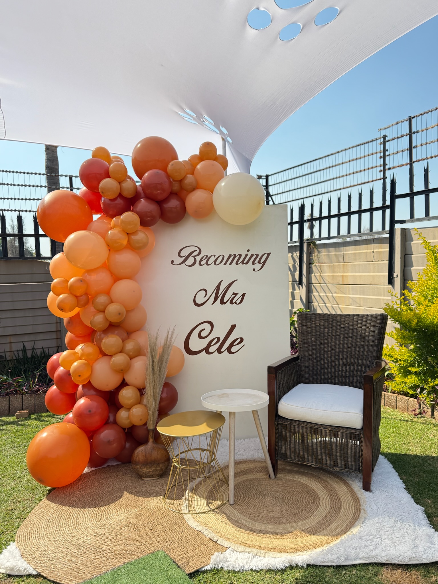 Elegant balloon arc and signage at an Elora Events celebration