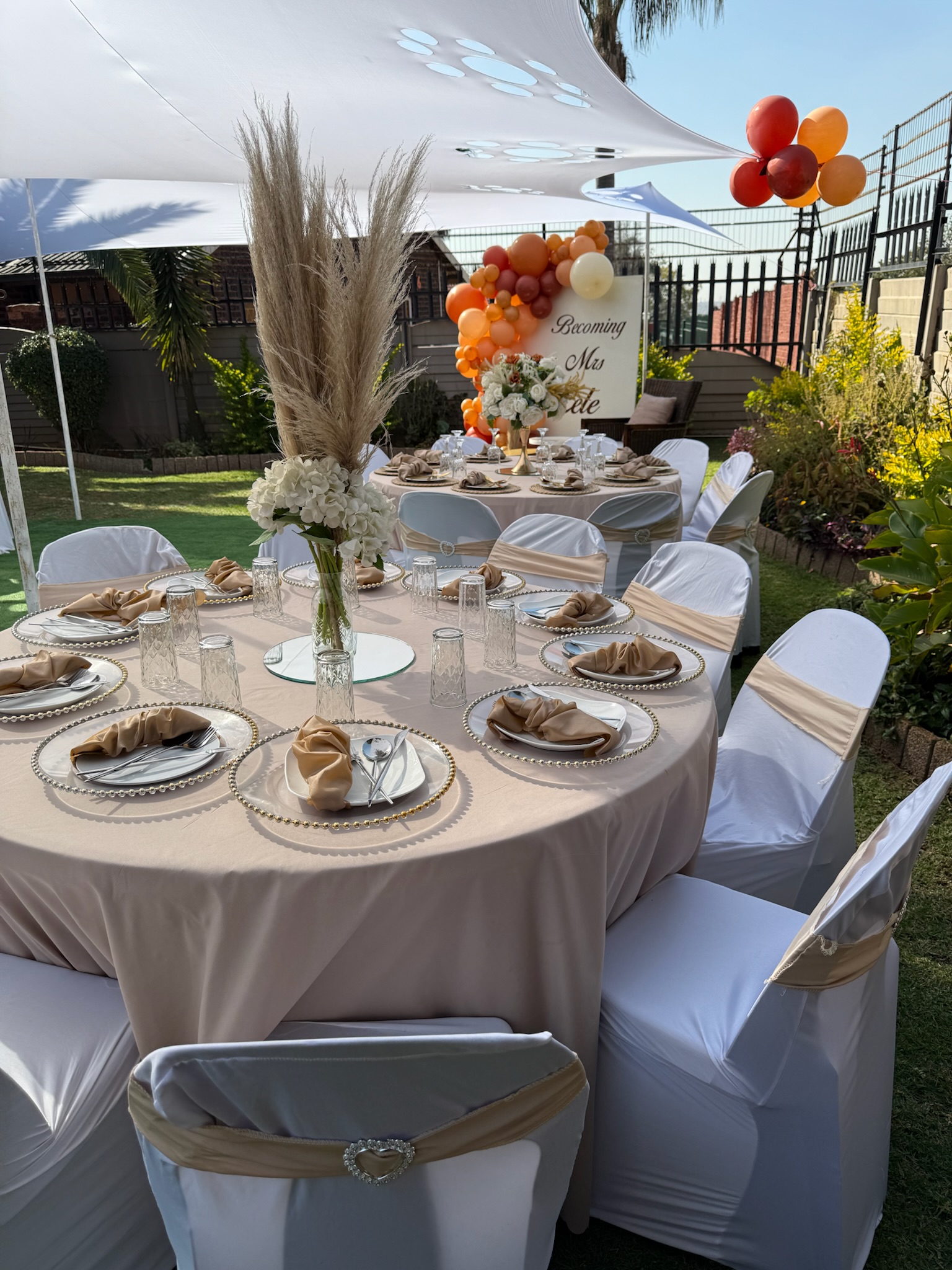 Styled outdoor celebration with floral and decor arrangements