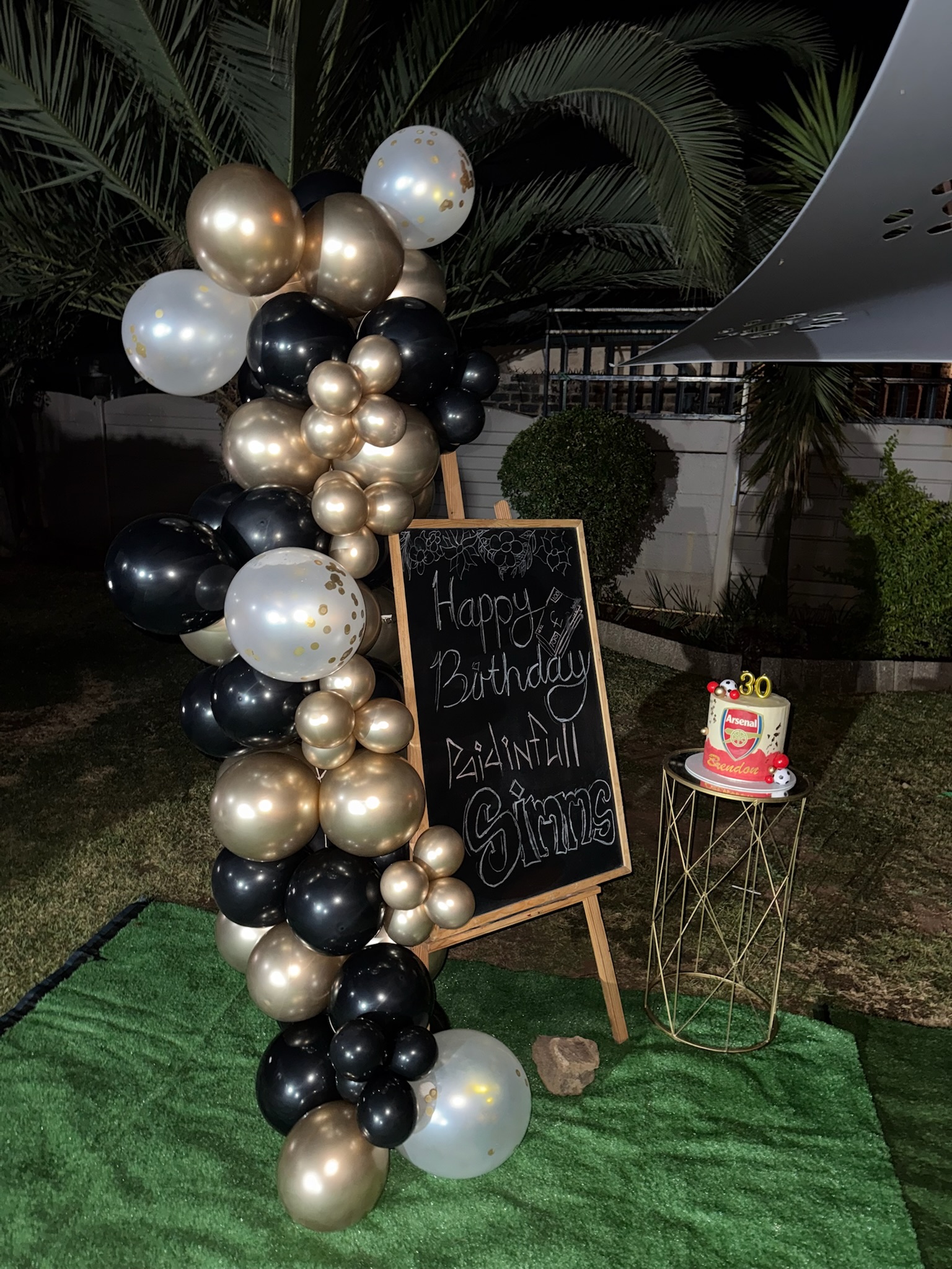 Birthday balloon garland with chalkboard signage and custom cake