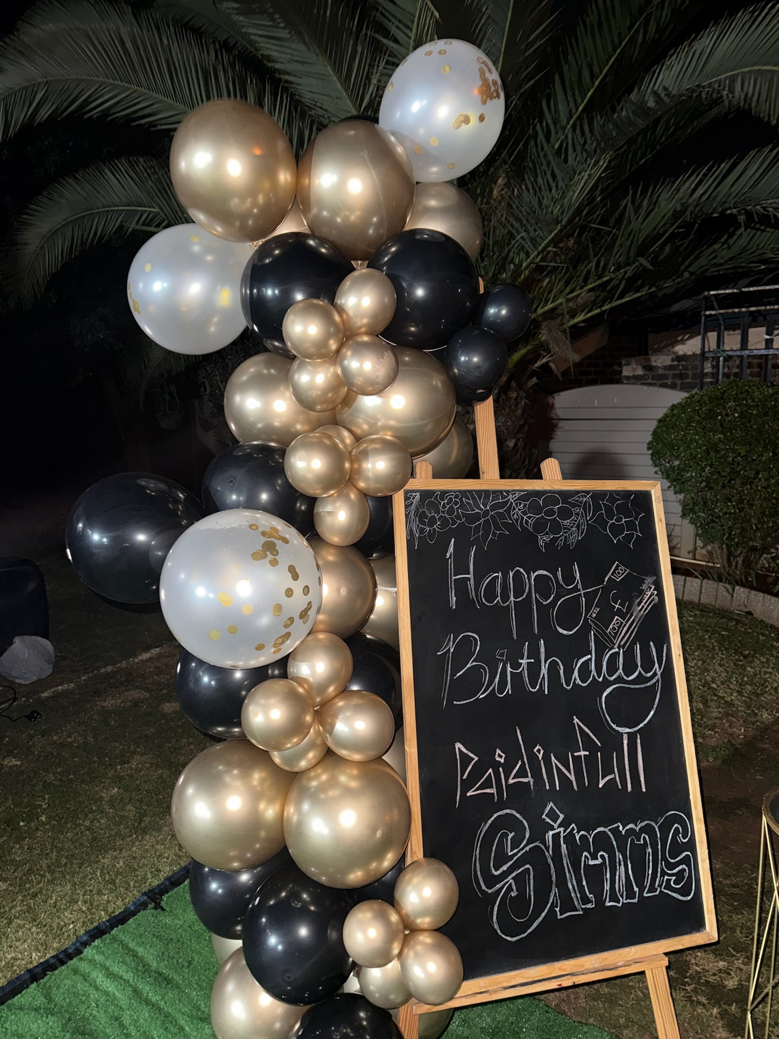 Festive celebration with themed balloon installation and backdrop